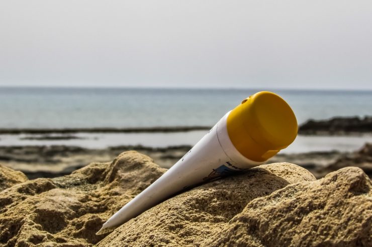 sunscreen container on beach